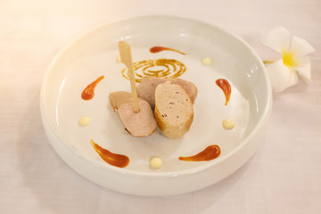Baked homemade sausage on a white plate. 