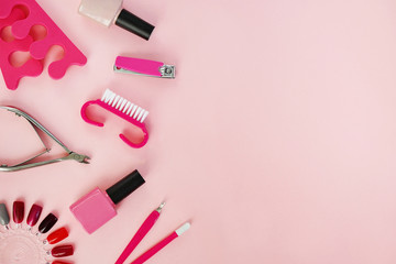 flat lay of manicure and pedicure tools on pink table