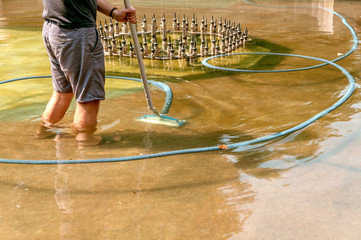 clean the fountain in the city park