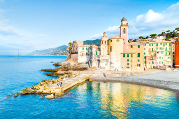 Scenic Mediterranean riviera coast. Panoramic view of Camogli town in Liguria, Italy. Basilica of Santa Maria Assunta and colorful palaces. Liguria, Italy