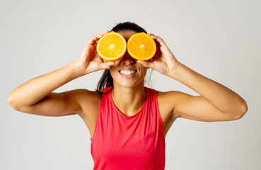 Portrait of cheerful funny and attractive woman holding sliced orange over her eyes