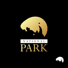 Gold silhouette of elephant and rhino logo template on black background. Beautiful logo for zoos, nature reserves and national parks. Vector illustration.