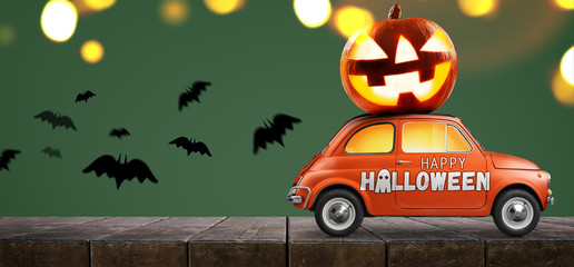 Halloween car delivering pumpkin against green background