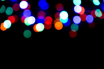 The colorful bokeh on the blurred natural black background.