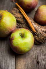 Fresh ripe apples on the wooden background. Selective focus. Shallow depth of field.
