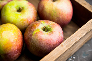 Fresh ripe apples on the wooden background. Selective focus. Shallow depth of field.