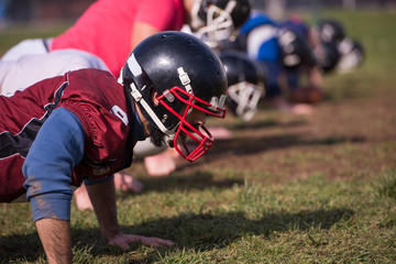 american football team doing push ups