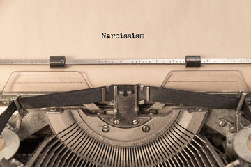 Narcissism on a sheet of paper typed on a retro typewriter. writer, journalism.