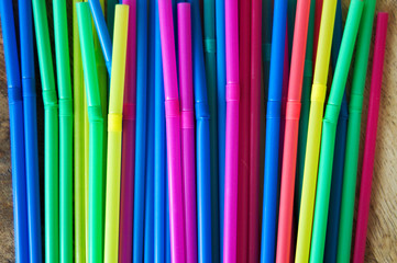 Colored plastic bendy straws close up side view.