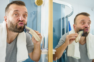 Man shaving trimming his beard
