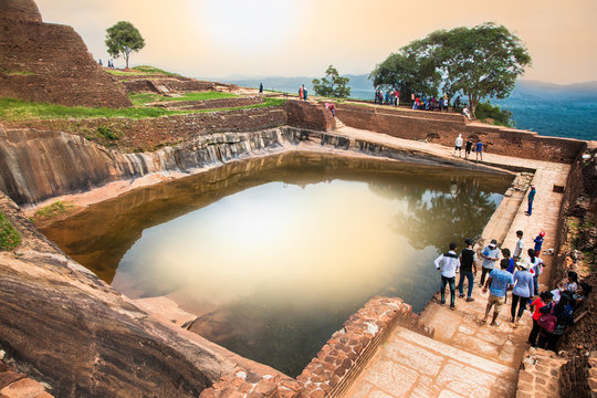 Tourists are waiting to climb on Sigiriya rock fortress in Sigiriya , Sri Lanka.