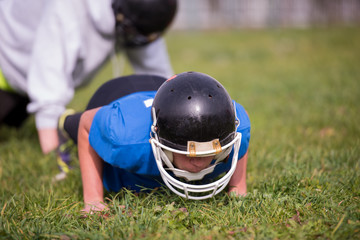 Fototapeta premium american football player doing push ups