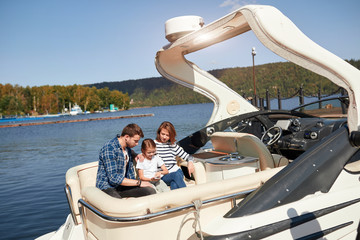 Family with daughter spending time together on sailboat