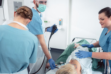 Team of doctors in hospital at endoscopy examining pictures during gastroscopy 