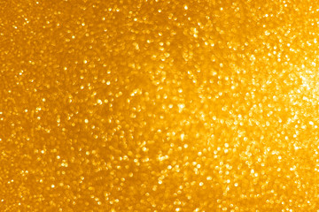 Luxury dark gold christmas asymmetric bokeh background. Abstract texture with defocused golden lights