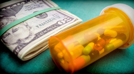 Container pills next to a ticket dollars, conceptual image