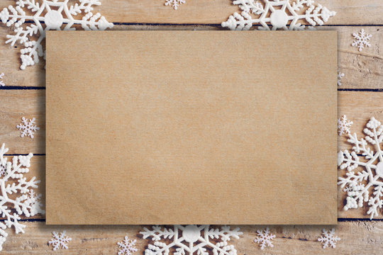 Wooden Brown Christmas Background With Snowflakes And Old Brown Paper With Space.