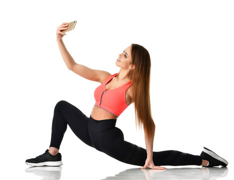 Sport woman gymnastics doing stretching fitness exercise workout and make selfie on her cellphone mobile 
