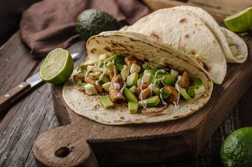 Homemade chicken thigh grilled, fresh avocado in tortilla