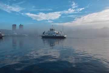 Boat on the sea at morning fog. Oslo, Norway