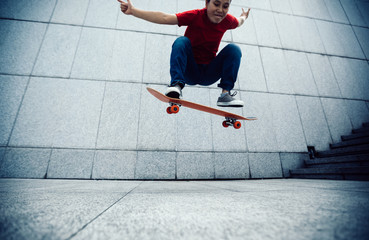 Skateboarder doing ollie at city