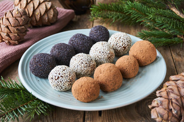 Homemade candies with dried fruits and nuts on a plate   