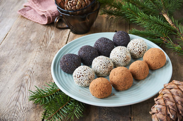 Homemade candies with dried fruits and nuts on a plate   