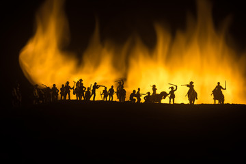 Fototapeta na wymiar American Civil War Concept. Military silhouettes fighting scene on war fog sky background. Attack scene.