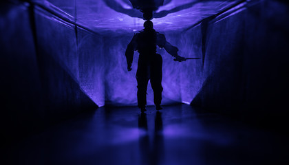 Creepy silhouette in the dark abandoned building. Horror about maniac concept or Dark corridor with cabinet doors and lights with silhouette of spooky horror person