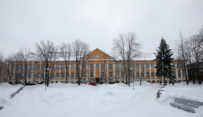 old long yellow building in a winter park