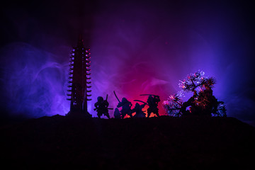 Samurai fighting concept. Silhouette of samurais in duel near tree and old temple. Picture with two...