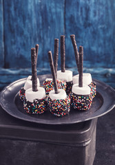 Chocolate covered marshmallows on blue