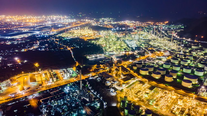 Oil storage tank with oil refinery background, Oil refinery plant at night.Aerial view from drone top view