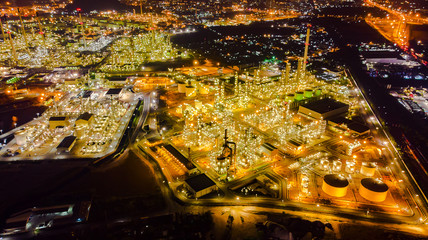 Oil storage tank with oil refinery background, Oil refinery plant at night.Aerial view from drone top view