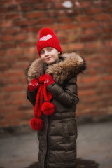 Fall fashion. Kid girl wear coat for fall season. Girl looking face cute hairstyle fashionable fall coat with hood and fur. Child cheerful walking wearing warm bright coat or jacket.
