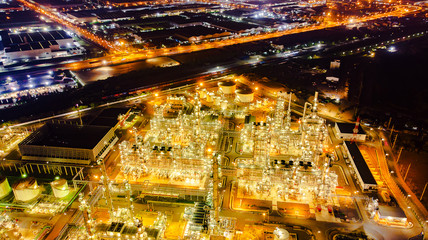Fototapeta na wymiar Oil storage tank with oil refinery background, Oil refinery plant at night.Aerial view from drone top view