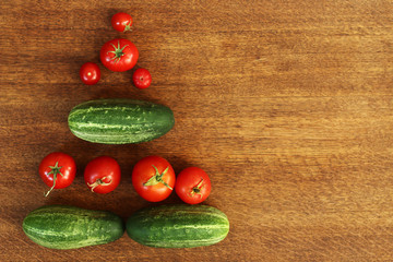 top view of fresh organic home grown vegetables on a brown wooden table. tomatoes, cucumbers and peas