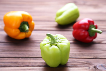 Colorful pepper on a brown wooden background