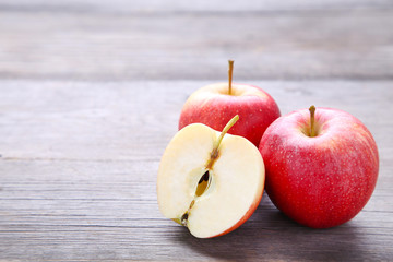 Fresh red apples on a grey wooden background