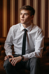 Portrait of young man in a business suit. Vertical frame