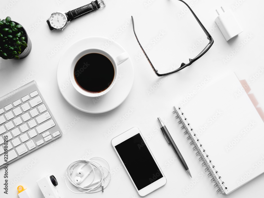 Poster top view of office desk workspace with notebook, smartphone and gadget on white background with copy