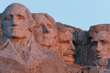 A close-up view of the four Presidents in Mount Rushmore at dawn