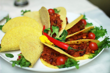 small filled corn tortillas on plate