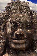 Stone carved face at Bayon Temple in Angkor Wat complex in Siem Reap city, Cambodia. Ancient Khmer architecture