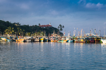 Fototapeta na wymiar Hundreds of old colorful boats in fisheries harbor, Mirissa ,Sri Lanka.