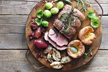 Roast beef with yorkshire pudding, brussels sprouts, porcini mushrooms and shallots. Traditional british roast beef. Overhead view