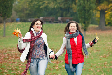 Two pretty girls walking in the park