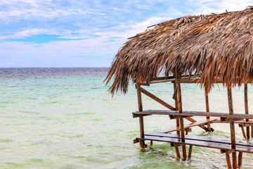 Fototapeta na wymiar Beach hut with palm roof on the beach. Paradise Island, Dominican Republic.
