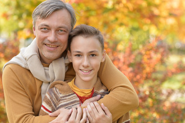 Portrait of father and boy in autumn park