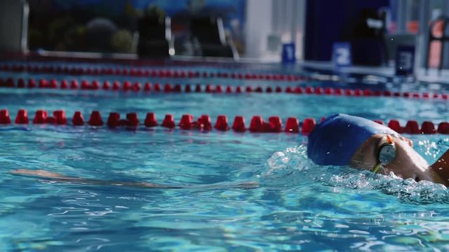 Attractive young swimmer in the swimming pool